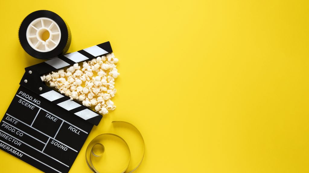 top-view-arrangement-cinema-elements-yellow-background-with-copy-space