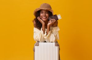 Happy woman with suitcase and passport